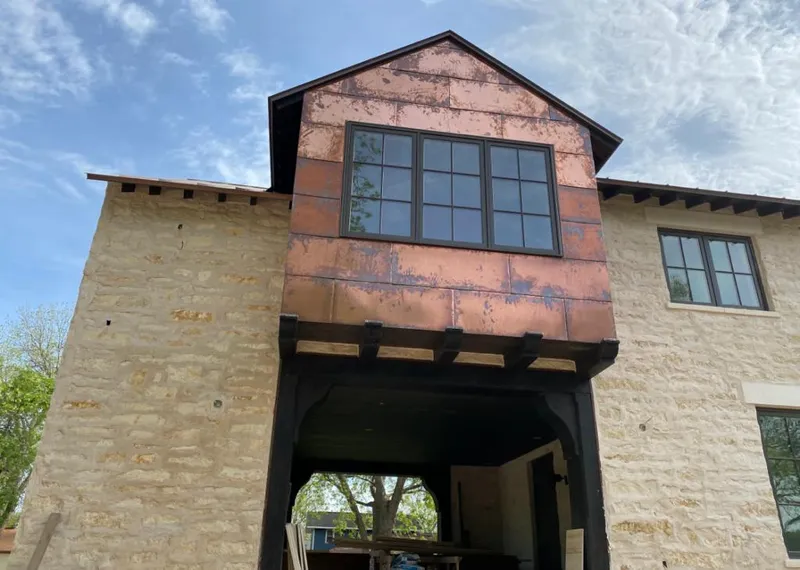 Copper metal panel facade on a stone building for Metal Roof Coating in Birch Run